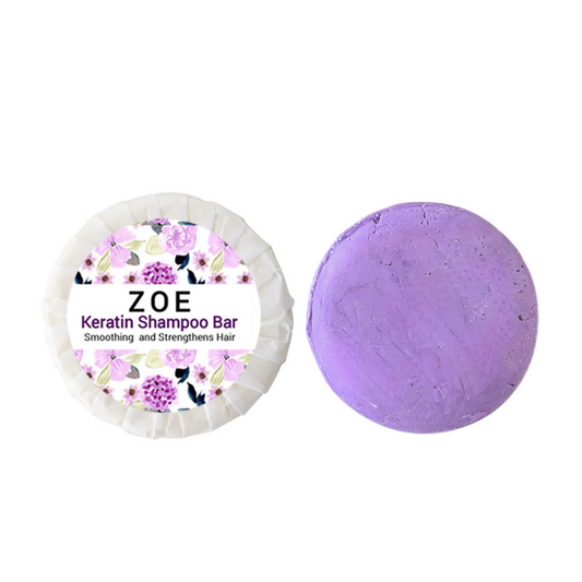 A purple-colored Zoe Keratin Shampoo Bar with floral patterns on the packaging, indicating it is a solid shampoo product.