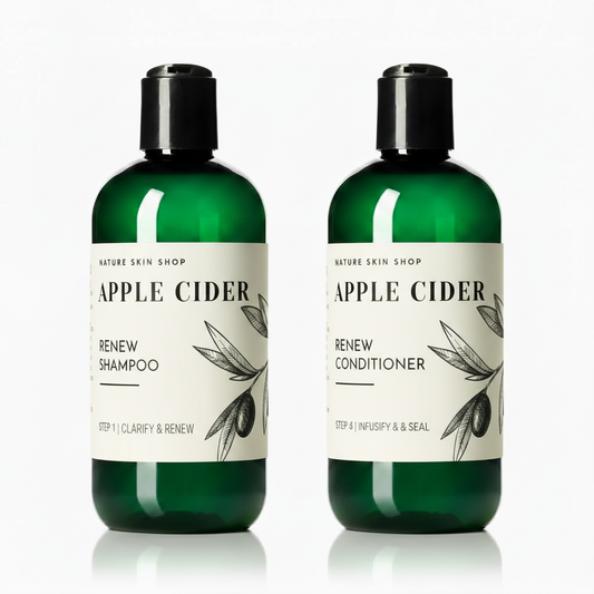 Two bottles of Apple Cider Renew Shampoo and Conditioner from Nature Skin Shop on a white background
