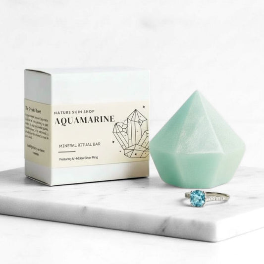 Aquamarine mineral ritual bar with packaging and a ring on a marble surface