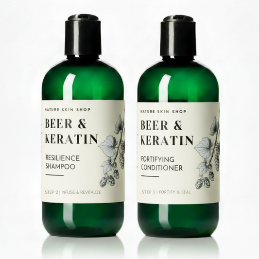 Two green bottles of 'Beer & Keratin' shampoo and conditioner on a white background