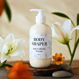 Body Shaper anti-cellulite cream bottle with flowers and pebbles in the background Body Shaper anti-cellulite cream bottle with flowers and pebbles in the background
