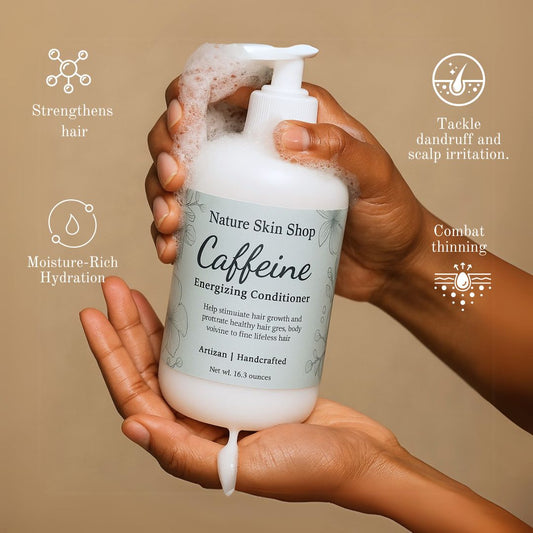 Hand holding a bottle of 'Nature Skin Shop Caffeine Energizing Conditioner' with product features listed on a beige background.