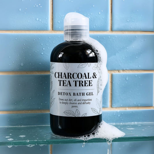 Bottle of Charcoal & Tea Tree Detox Bath Gel on a glass surface with tiled background