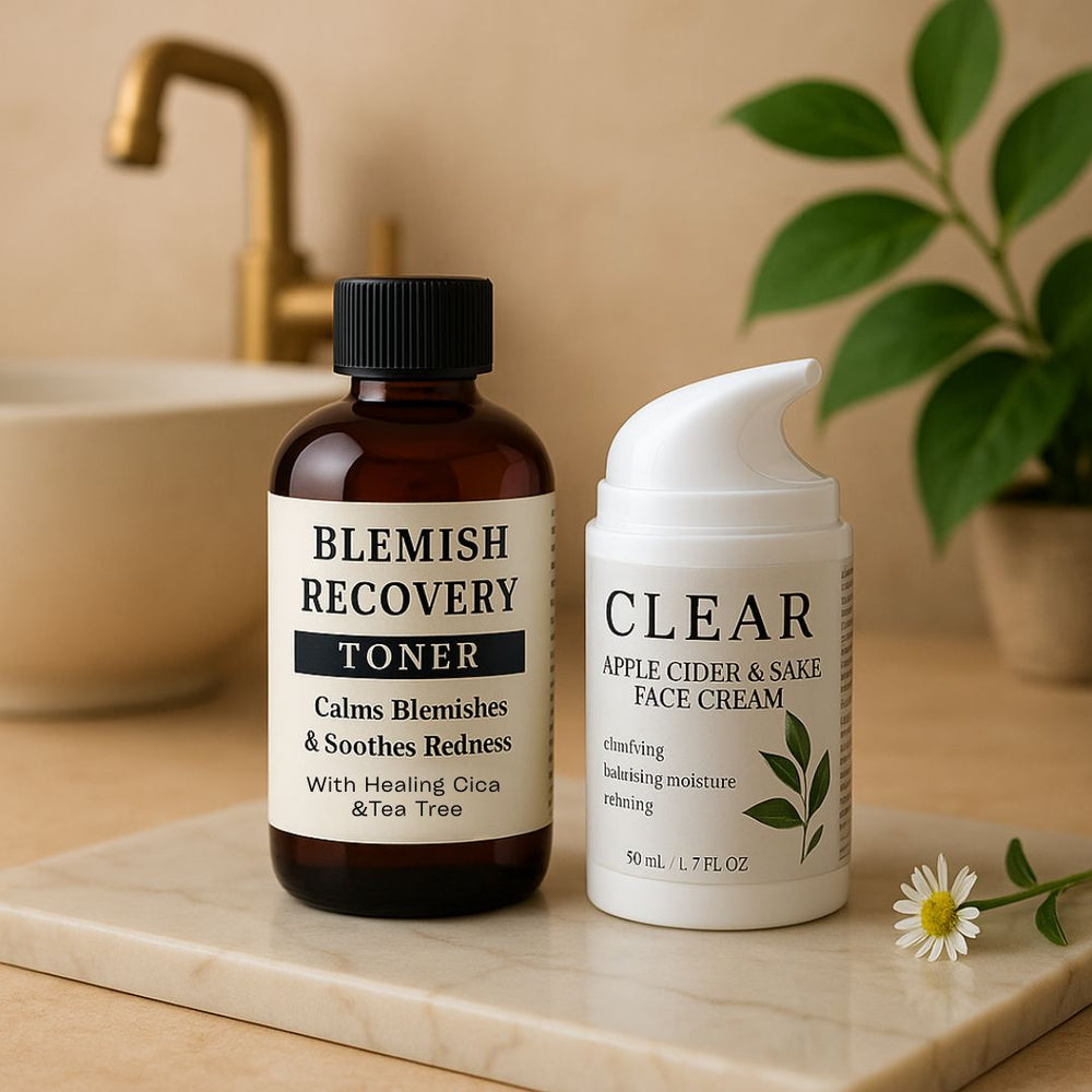 Blemish Recovery Toner and Clear Apple Cider & Sake Face Cream on a marble surface with a plant in the background.