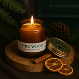 Candle labeled 'Fire Wood' with cinnamon sticks and dried oranges on a wooden board. Candle labeled 'Fire Wood' with cinnamon sticks and dried oranges on a wooden board.
