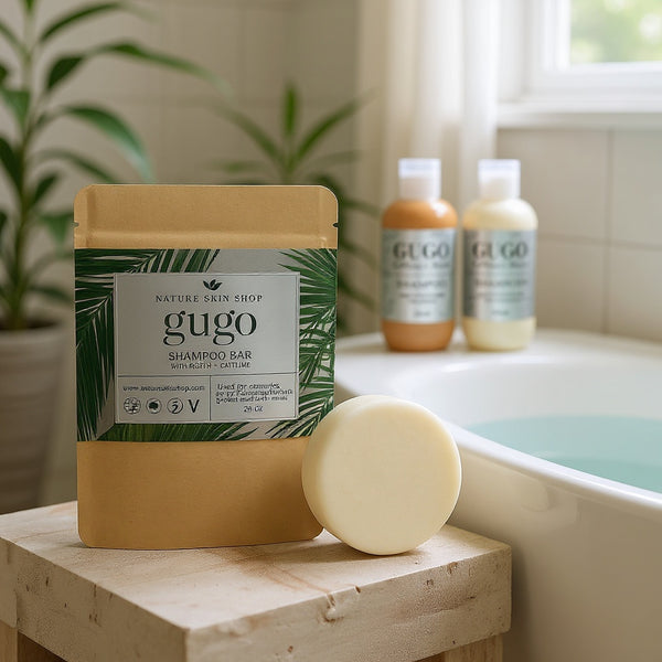 Gugo shampoo bar and bottles on a bathroom counter with plants in the background