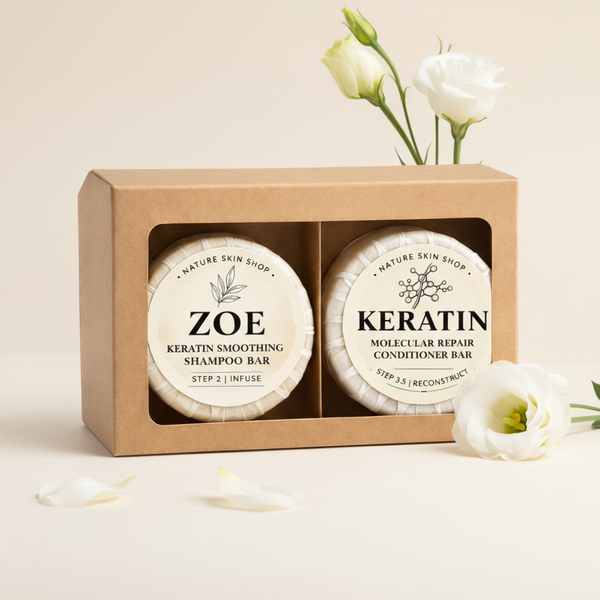 Two shampoo bars in a box labeled 'Zoe' and 'Keratin' with white flowers on a beige background.