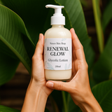 Bottle of 'Renewal Glow' Glycolic Lotion held by hands with a green leafy background Bottle of 'Renewal Glow' Glycolic Lotion held by hands with a green leafy background