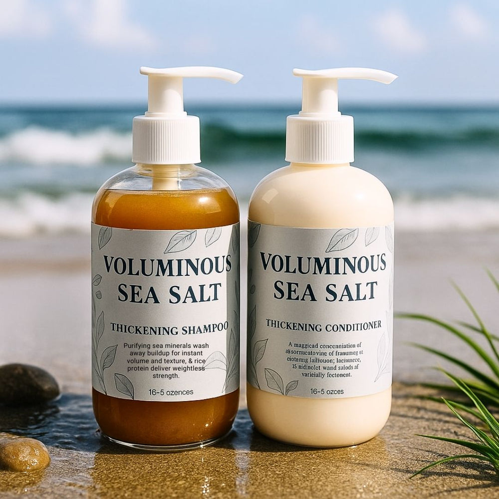 Two bottles of voluminous sea salt thickening shampoo and conditioner on a beach.