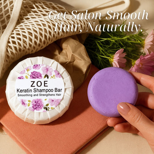 ZOE Keratin Shampoo Bar with a purple bar of soap on a textured surface with flowers.