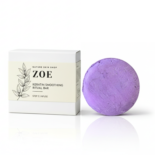 Purple bath bomb with packaging labeled 'ZOE' on a white background