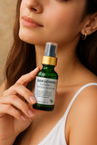 Woman holding a green bottle labeled 'Bakuchiol Nature's Elixir Serum' against a neutral background