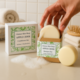 Apple cider shampoo and conditioner bars from Nature Skin Shop on a bathroom counter.