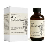 Skin balancing toner bottle and packaging with branding on a white background