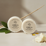 Two Amla soap bars from Nature Skin Shop on a neutral background with leaves and oil droplets.