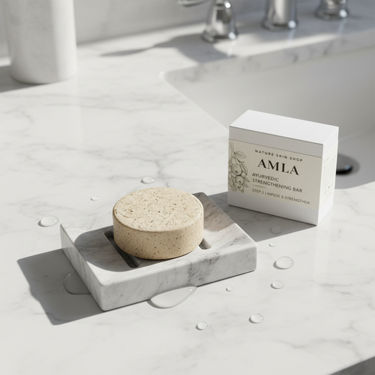 Soap bar on a marble soap dish with a box labeled 'AMLA' in a bathroom setting.