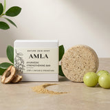 Amla Ayurvedic Strengthening Bar from Nature Skin Shop with packaging, a bar, and fruits on a neutral background.