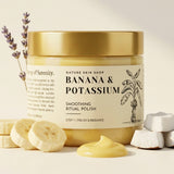 Jar of 'Banana & Potassium' smoothing ritual polish from Nature Skin Shop on a light background with banana slices and coconut pieces.