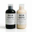 Two bottles of 'Beer Shine' shampoo and conditioner on a white background