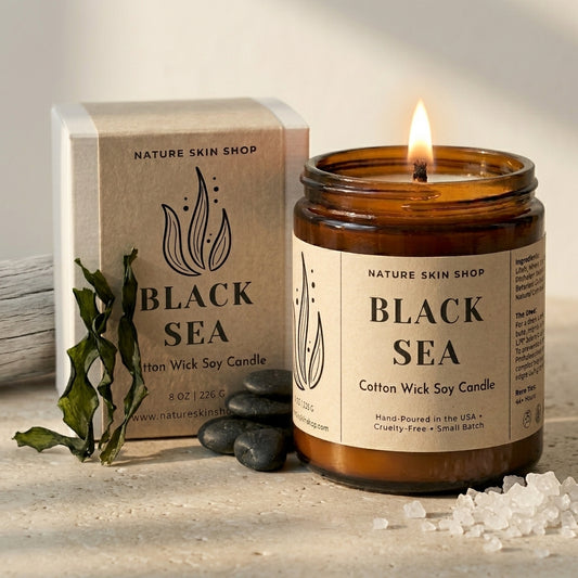 Black Sea candle from Nature Skin Shop with packaging and decorative elements on a neutral background