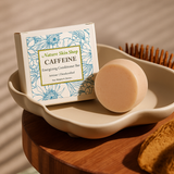 Nature Skin Shop caffeine soap bar on a white dish with packaging in the background.