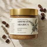 Jar of 'Aromatic Arabica' whipped ritual polish with coffee beans and a gold lid on a beige background.