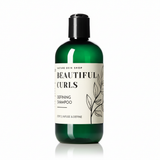 Green shampoo bottle with a label on a white background