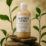Bottle of 'Beautiful Curls' hair care product on a stone surface with plants in the background