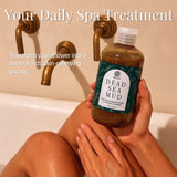 Person holding a bottle of Dead Sea Mud with text about a daily spa treatment.