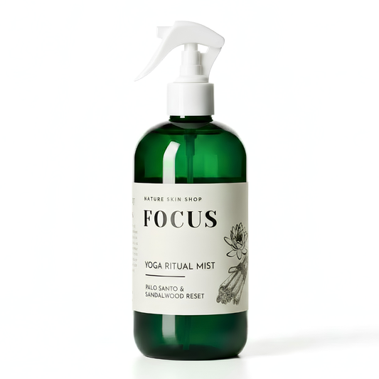 Green bottle of 'Focus' yoga ritual mist with a white label on a white background
