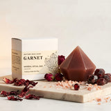 Garnet mineral ritual bar with geometric soap and dried flowers on a light background
