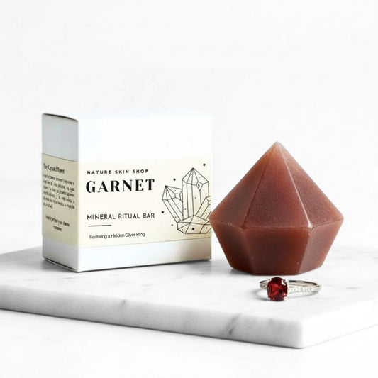 Garnet mineral ritual bar with packaging and a ring on a marble surface