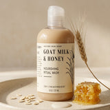 Bottle of Goat Milk & Honey Nourishing Ritual Wash with honeycomb and oats on a neutral background