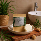 Gugo shampoo bar packaging with a bar of soap in a bowl on a wooden tray in a bathroom setting.