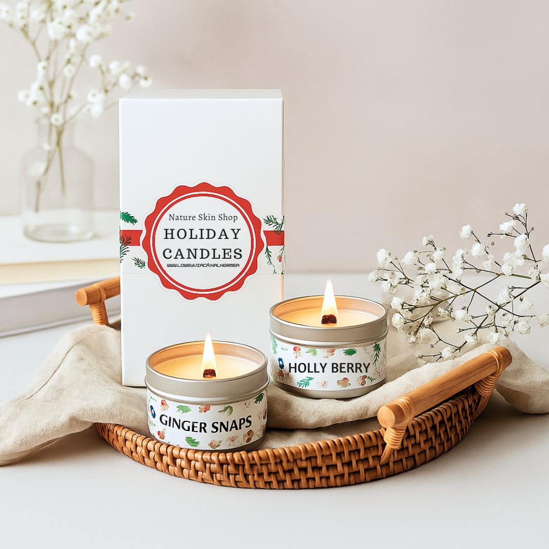 Two lit candles on a tray with 'Nature Skin Shop Holiday Candles' packaging in the background.