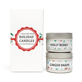 Two holiday candles labeled 'Holly Berry' and 'Ginger Snaps' with a branded box on a white background.