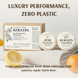 Keratin bio-structural repair set with shampoo and conditioner bars on a towel, surrounded by lemons and oranges.