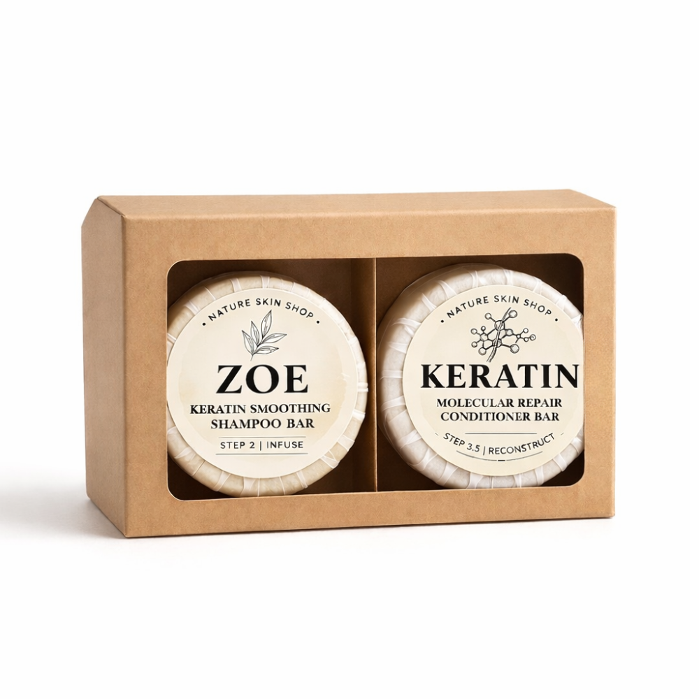 Two shampoo bars in a cardboard box labeled 'Zoe' and 'Keratin' on a white background.