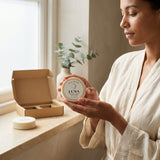 Woman holding a container labeled 'LUNA' in a cozy indoor setting.