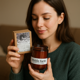 Woman holding a jar and box of 'Middle Earth' candles.