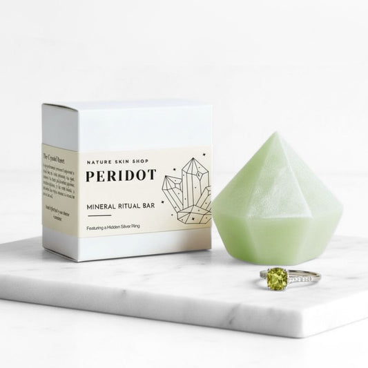 Peridot mineral ritual bar with packaging and a ring on a marble surface