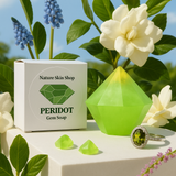Peridot gem soap with packaging and a ring on a natural background