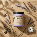 Phoenix soy candle on a wooden surface with lavender and rocks