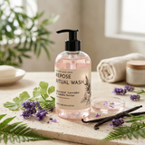 Bottle of 'Repose Ritual Wash' with lavender and vanilla beans on a wooden surface