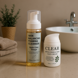 Two skincare products on a bathroom counter with a sink and plant in the background.