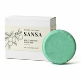 Green soap bar next to its packaging with 'Sansa' branding on a white background