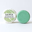 Green shampoo bar with packaging labeled 'Sansa ACV Shampoo Bar' on a white background