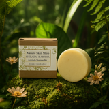 Nature Skin Shop shampoo bar and packaging on a green background with plants and flowers