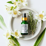 Skincare bottle labeled 'Skin Tight' on a white plate with flowers and greenery