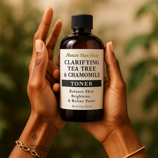 Bottle of Clarifying Tea Tree & Chamomile Toner held by hands with a blurred green background